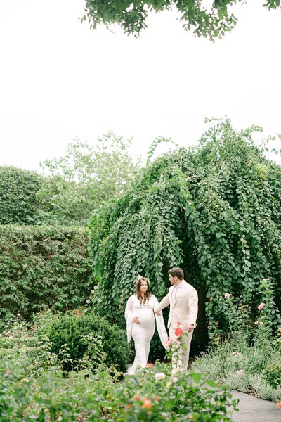portrait of a couple during their maternity session in a garden