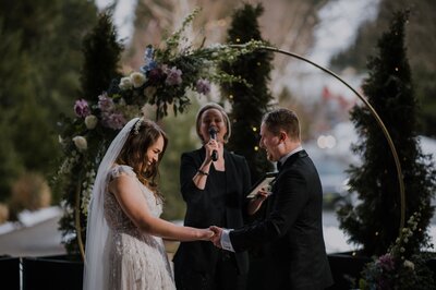 officiant laughing with bride and groom at ceremony