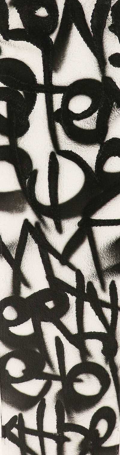 An abstract texture created with black strokes of spray paint over a white textured wall