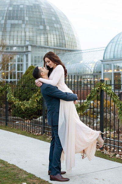 Couple celebrating engagement in park