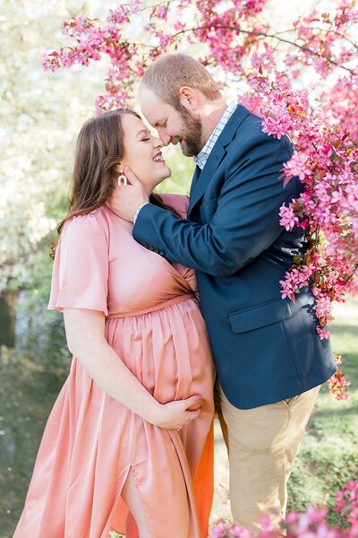 A couple stands outdoors in spring for Maternity portraits by Katelyn Ng Photography, Indianapolis photographer