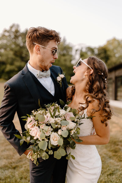 bride and groom posing on beach