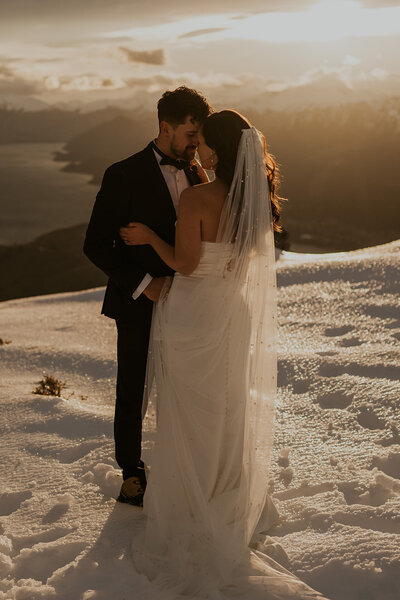 amy and nick embrace on mountain