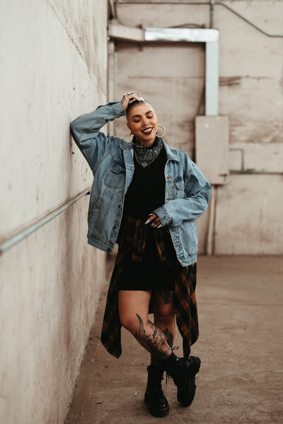 queer wedding photographer in Colorado posing in an urban setting