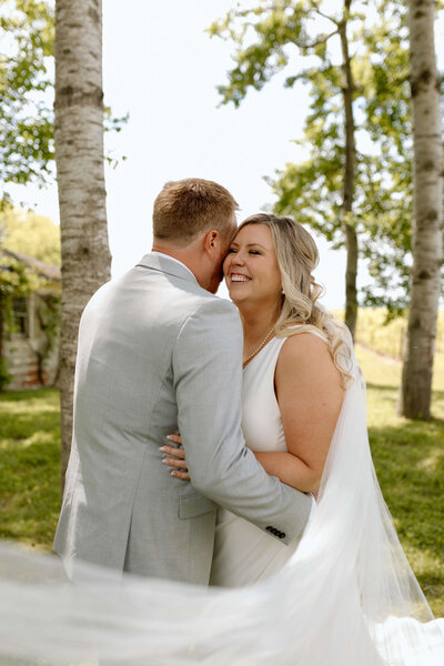 A couple embracing during their first look at a winery near King Township, Ontario