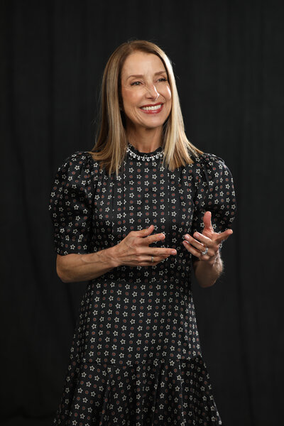 Nancy Himmelfarb speaking confidently at an event, engaging the audience with her insights on sustainability