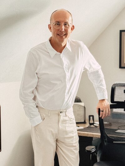 Erich Fogg casually standing in a studio, approachable and professional PANCE coach