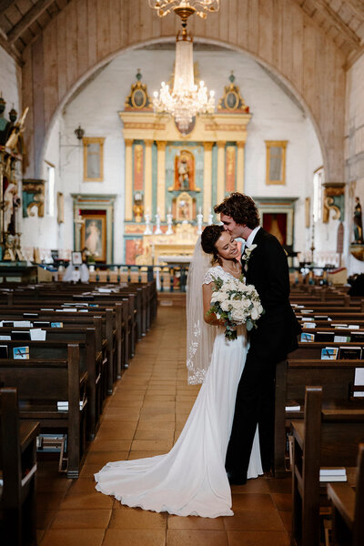 a bride and groom in a Catholic Church