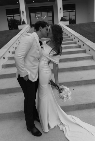 bride and groom share a kiss after wedding in texas