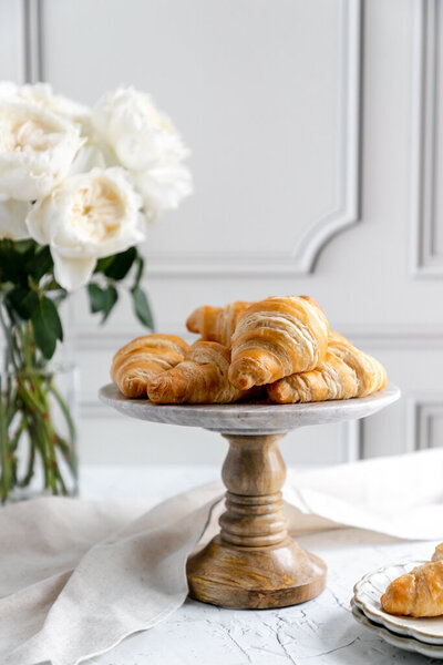 croissants stacked on top of a cake tray