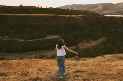 girl standing on hillside in columbia river gorge