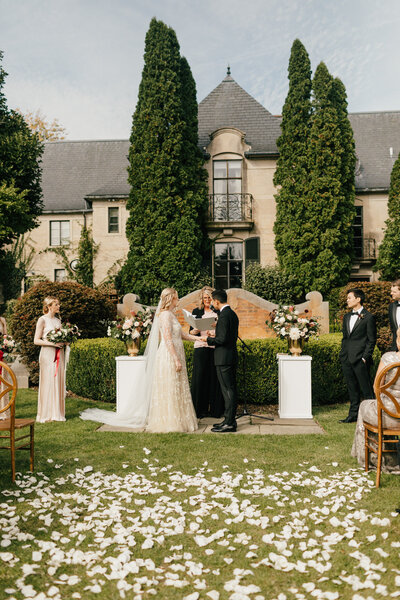 wedding couple kissing in front of mansion