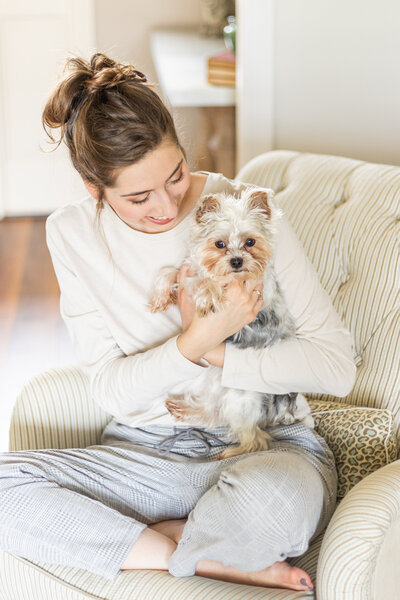 Ramsey smiling at her puppy