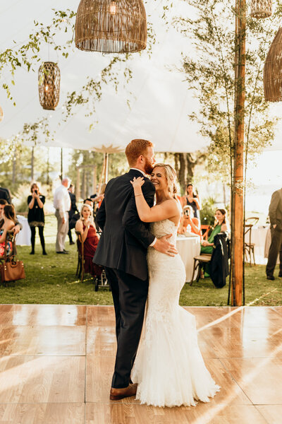 couple dancing under wedding tent