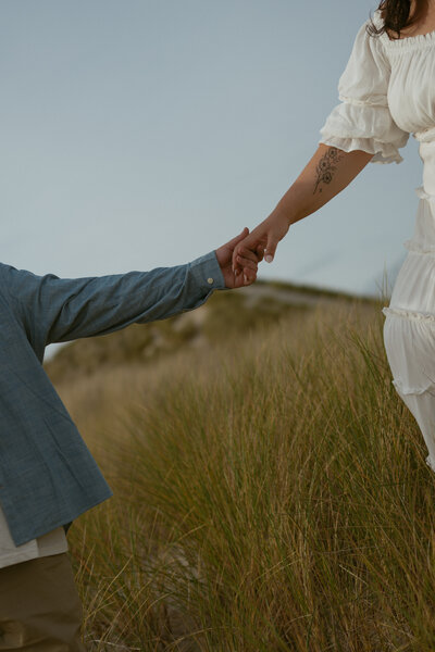 Hand detail of couple walking