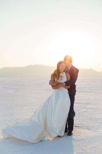 couple hugging in desert during outdoor bridals