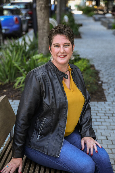 woman wearing all black  using a large professional camera for photography
