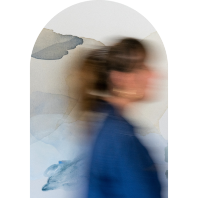 Brand photography of a blurry figure in front of an abstract painting