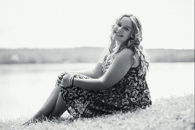 Photo of girl sitting with hands on her knees | Senior Portraits