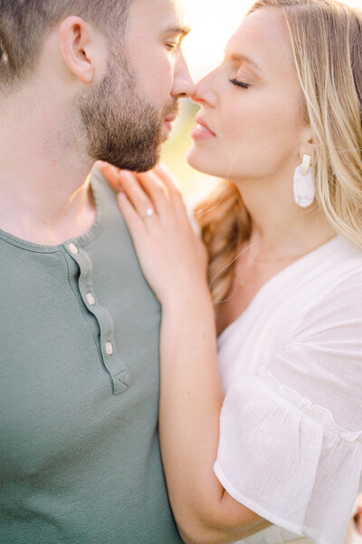 couple facing each other with their eyes closed about to kiss