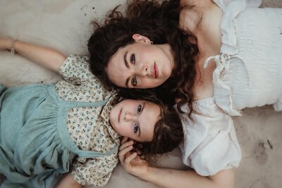 Mother and Daughter photo shoot in Texas. Photo of them laying in the sand next to each other