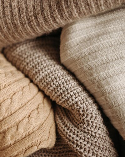 Cozy neutral knit textures used in Modern Mollusk home staging projects, reflecting warm, approachable design style.