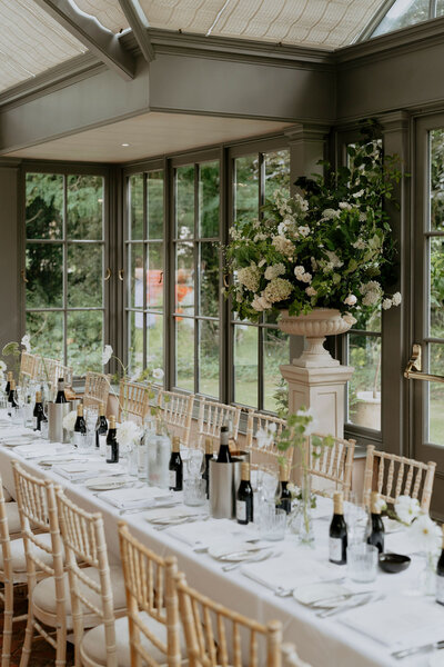 Large urns of flowers behind the tables at The Rectory Hotel, Crudewell