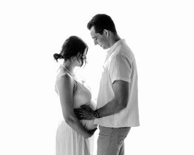 husband and wife holding ultrasound for maternity photoshoot