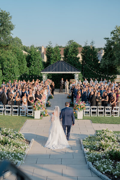 Ceremony scene of bride and dad walking down the aisle at Cape May New Jersey wedding
