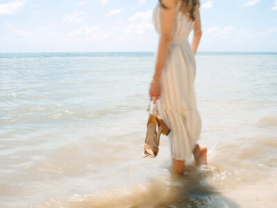 Kilee in a striped dress standing in the ocean
