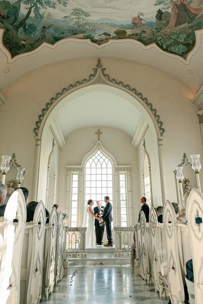 Elegant wedding at Trump Chapel in Charlottesville, Virginia, featuring a bride and groom exchanging vows in a timeless chapel setting with stunning views and historic charm