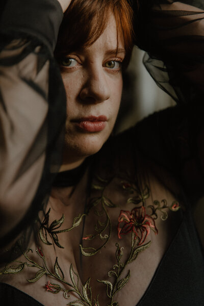 moody sunset golden hour outdoor brand headshot of Annie in natural light with rays of sunshine
