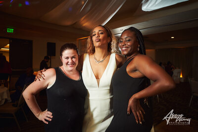 Bride posing with friends at wedding reception