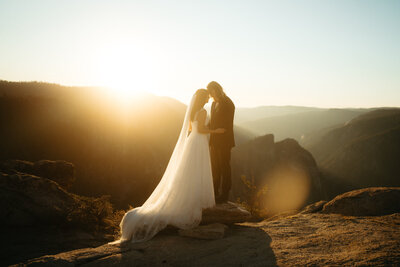Glacier Point Amphitheater Wedding  with guests seated in the amphitheater and Half Dome in the background