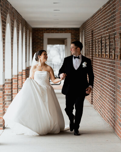 A couple runs for a fun portrait at St. Ann's Catholic church following their downtown Nashville, TN Catholic wedding Mass