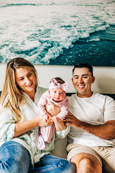 sweet moment of family with new baby in thier bed