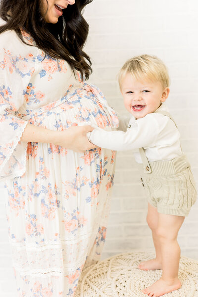 Little boy touching mama's pregnant belly