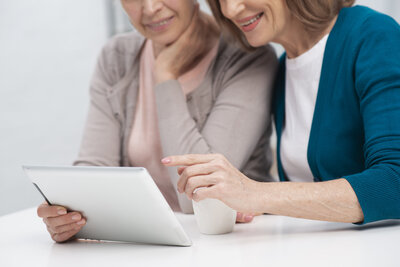 Women working together on a project in an office.