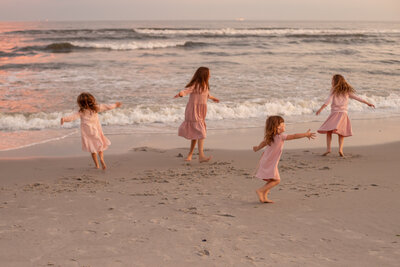 four sisters dancing on the beach