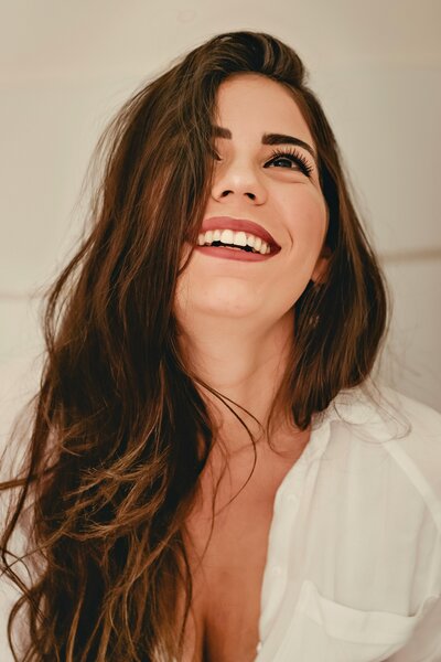 woman smiling after getting makeup services