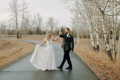 Wedding couple dancing in the park by the Lake House in Calgary
