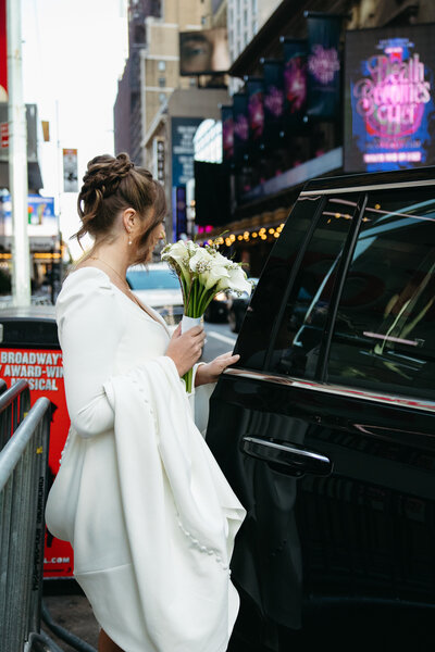 Bride getting in taxi cab in NYC Times Square