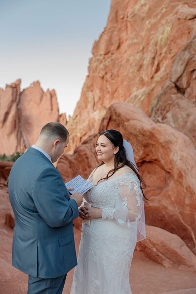 Colorado elopement photography with bride and groom smiling at each other exchanging vows
