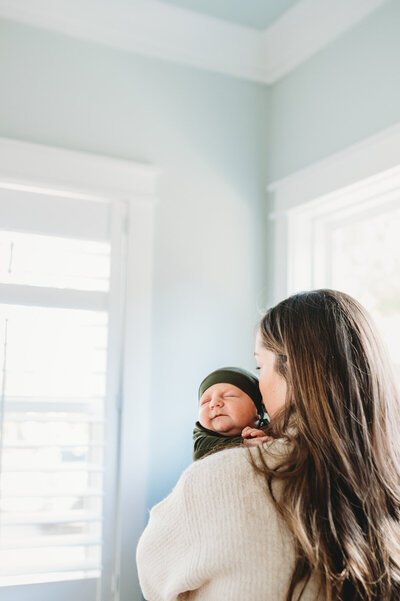 mom holding baby