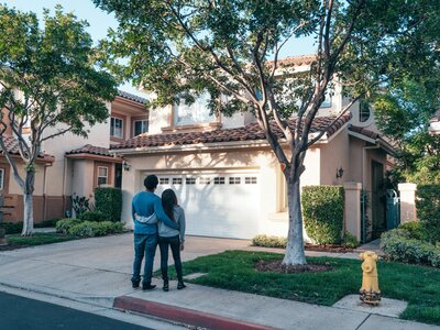 Young Black couple looking at their new home.