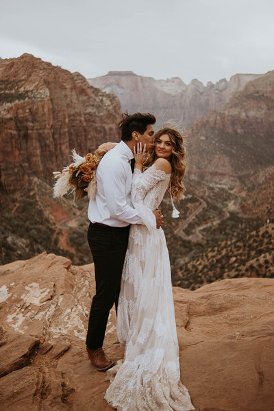 Groom kissing women on the cheek in Zion National Park