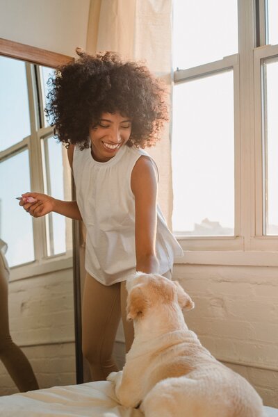 A woman and a dog sharing a moment, embodying a heartwarming companionship between human and canine