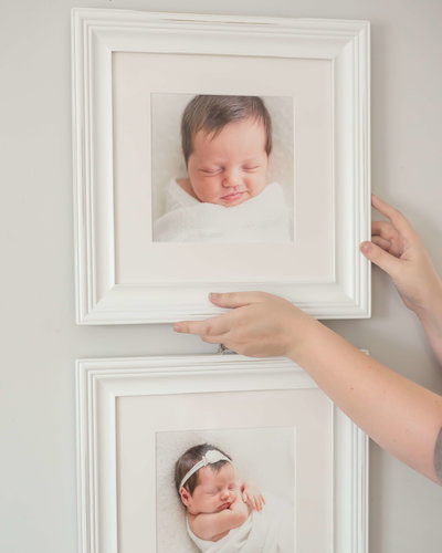 Hanging framed newborn artwork in houston home Hanging framed newborn artwork in houston home
