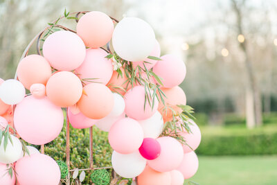A pink and white balloon arch at a wedding at Englund Estate in Cuthbert Georgia