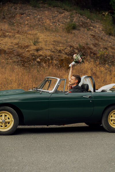 Bride and groom in their getaway car during their wedding at Caleb Pike in Victoria by Latitude 49 Photography
